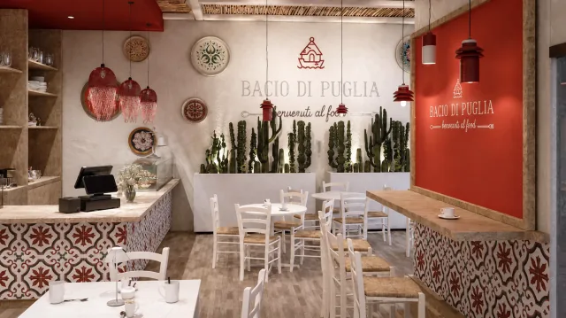 La sala di Bacio di Puglia a Bari, con sedie bianche, ceramiche e pareti rosse